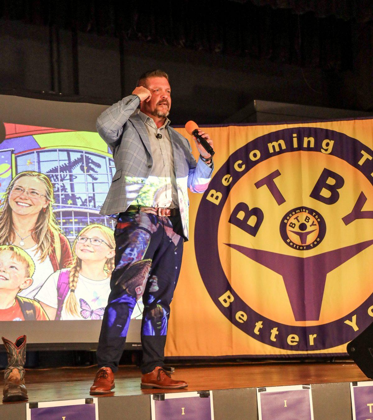 Steve speaking in front of a Becoming The Better You banner