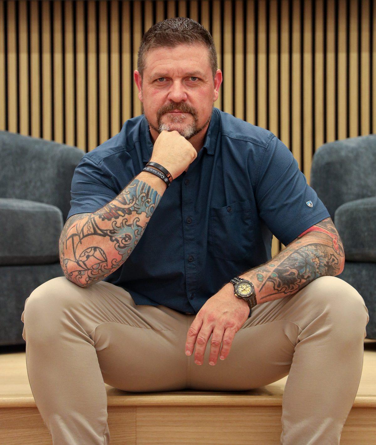 Portrait of Steve Baumgartner seated, chin resting on his hand